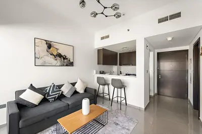 a living room with a couch and a table at VayK - Modern 1BR Apartment in Business Bay in Dubai