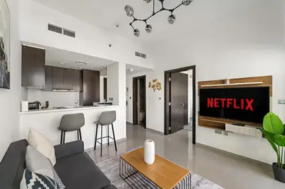 a living room with a couch and a kitchen at VayK - Modern 1BR Apartment in Business Bay in Dubai
