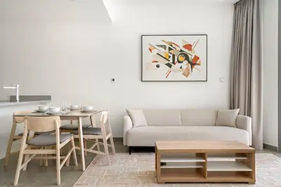 a living room with a couch and a table at VayK - Ocean View 1BR in the Heart of Dubai Marina in Dubai