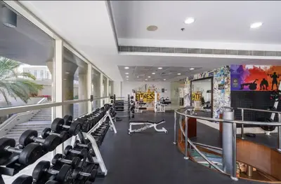 a gym with a lot of chairs and a lot at Premium One-Bedroom Apartment with Spectacular Marina View & Private Balcony by Dejaview Stays in Dubai