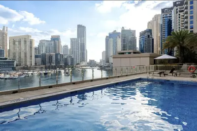 a large swimming pool on top of a city skyline at Premium One-Bedroom Apartment with Spectacular Marina View & Private Balcony by Dejaview Stays in Dubai