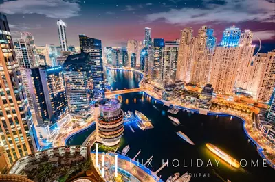 a view of a large city at night at LUX The JW Marina Suite 3 in Dubai