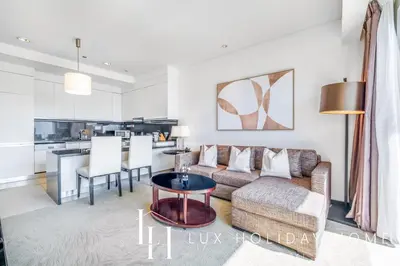 a living room with a couch and a table at LUX The JW Marina Suite 3 in Dubai