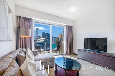 a living room with a couch and a large window at LUX The JW Marina Suite 3 in Dubai