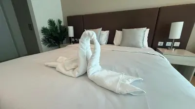 a towel animal is made to look like a whale on a bed at Highend Seven Palm 1BR Private Beach and Infinity Pool in Dubai