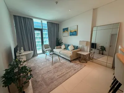a living room with a couch and a large window at Highend Seven Palm 1BR Private Beach and Infinity Pool in Dubai