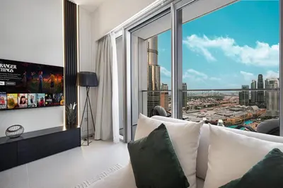 a living room with a view of a city at SkyHigh Luxury 2BR Burj View Private Hot Tub Walk to DubaiMall in Dubai