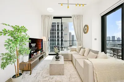 a living room with a couch and a tv at Stunning 2BDR Luxury Private Pool and Terrace in Dubai
