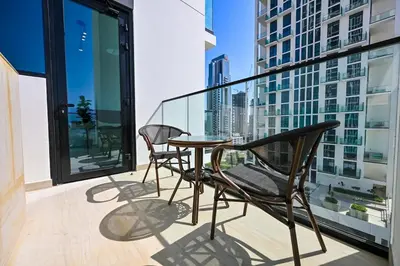 a balcony with a table and two chairs on it at Stunning 2BDR Luxury Private Pool and Terrace in Dubai