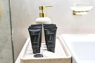 a bathroom with two products sitting on a sink at Stunning 2BDR Luxury Private Pool and Terrace in Dubai
