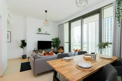 a living room with a table and a couch at Elite Escape Holiday Home - 1 BHK Getaway with Dubai Mall Access - 3310 in Dubai