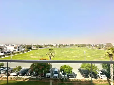 a view of a parking lot with cars parked at Bright & Airy 2BR Full Park View in Dubai