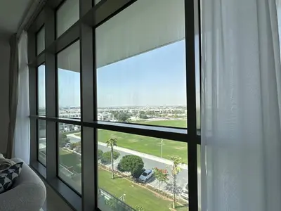 a room with a window with a view of a street at Bright & Airy 2BR Full Park View in Dubai