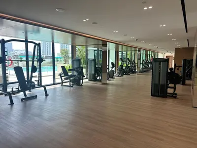 a gym with treadmills and ellipticals in a building at Cozy Apartment Gym Pool High 17th Floor JVC Gateway to Dubai in Dubai