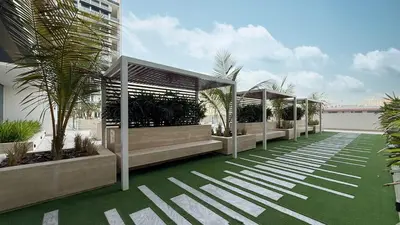 a row of gazebos on a building with palm trees at Cozy Apartment Gym Pool High 17th Floor JVC Gateway to Dubai in Dubai