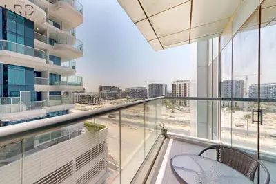 a balcony with a chair and a view of a city at Brand New & Modern 1BR Apartment in Dubai