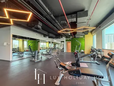 a gym with treadmills and elliptical machines at LUX Dubai Hills Sway Studio 2 in Dubai