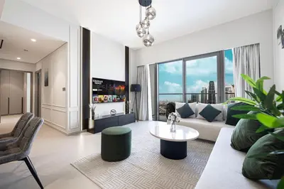 a living room with a couch and a table at SkyHigh 2BR Burj Views Steps to Dubai Mall in Dubai