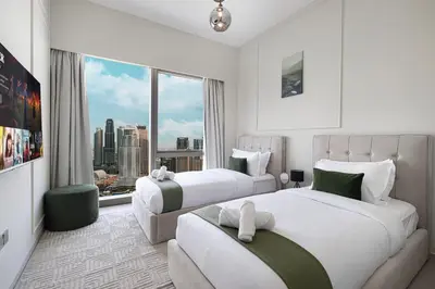 a hotel room with two beds and a large window at SkyHigh 2BR Burj Views Steps to Dubai Mall in Dubai