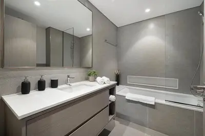 a bathroom with a sink and a shower and a tub at SkyHigh 2BR Burj Views Steps to Dubai Mall in Dubai