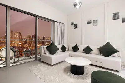 a living room with a couch and a table at SkyHigh 2BR Burj Views Steps to Dubai Mall in Dubai