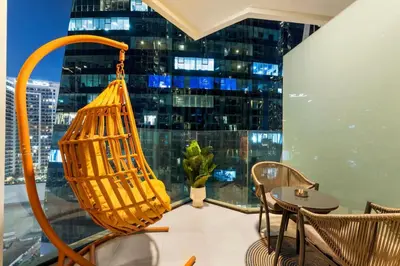 a room with a table and chairs and a large window at Luxe Studio Loft Type - Canal View - Fully Furnished in Dubai
