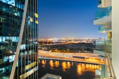 a view of a city at night from a skyscraper at Luxe Studio Loft Type - Canal View - Fully Furnished in Dubai
