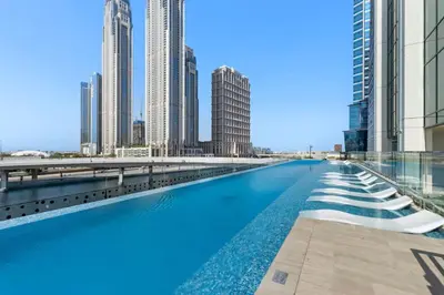 a swimming pool in the middle of a city with tall buildings at Luxe Studio Loft Type - Canal View - Fully Furnished in Dubai