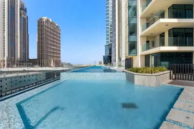 a swimming pool in a city with tall buildings at Luxe Studio Loft Type - Canal View - Fully Furnished in Dubai