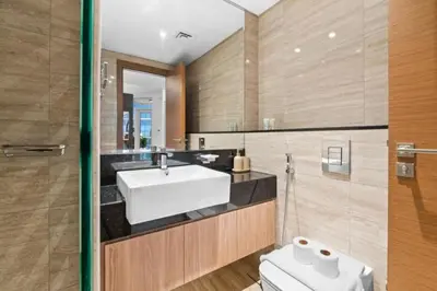 a bathroom with a sink and a toilet at Loft-Style Studio - Canal View - Fully Furnished - Near Dubai Mall - Burj Khalifa in Dubai
