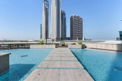a swimming pool on the roof of a building with tall buildings at Loft-Style Studio - Canal View - Fully Furnished - Near Dubai Mall - Burj Khalifa in Dubai