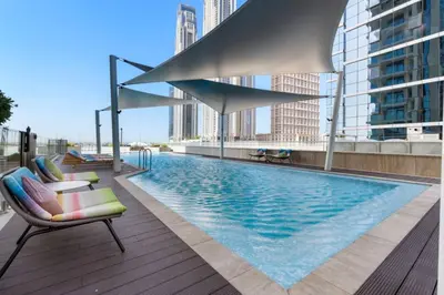 a swimming pool on the roof of a building at Loft-Style Studio - Canal View - Fully Furnished - Near Dubai Mall - Burj Khalifa in Dubai