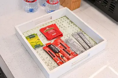 a drawer filled with different items on a counter at DTV 2BR Burj View, Pool in Dubai