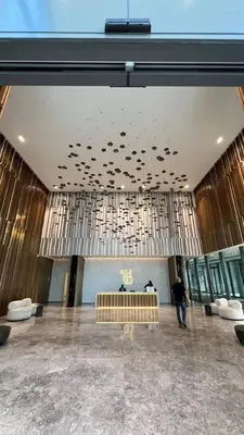 a man standing in a large room with a ceiling at Waterfront 1BR - Canal View - Fully Furnished in Dubai
