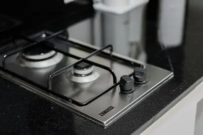a black stove top with two burners on a counter at Tranquil Haven Near Burj Khalifa in Dubai