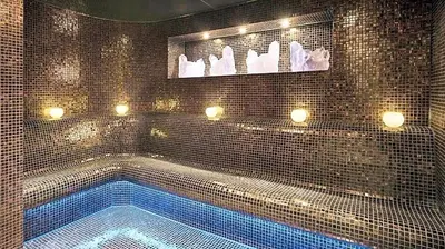 a bathroom with a swimming tub with lights on it at DAMAC 1BHK Apt Business Bay Dubai with Pool & Canal Walk in Dubai