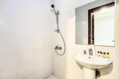 a white bathroom with a sink and a shower at Stylish 4BR Family Villa Easy Access to Dubai Marina & Expo City in Dubai