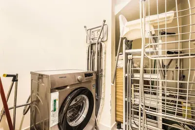 a washer and dryer in a laundry room at Stylish 4BR Family Villa Easy Access to Dubai Marina & Expo City in Dubai