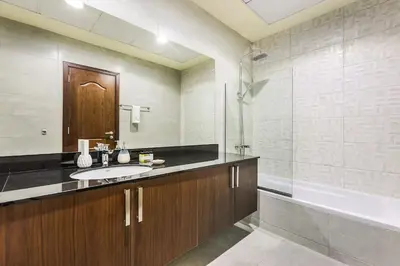 a bathroom with a sink and a bath tub at Stylish 4BR Family Villa Easy Access to Dubai Marina & Expo City in Dubai