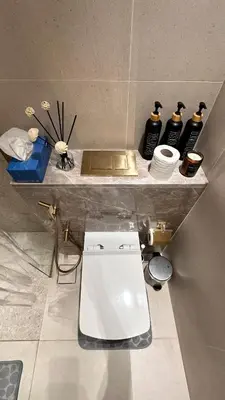 a bathroom with a white toilet on a counter at Lux Business Bay Studio with Jacuzzi & Canal View in Dubai