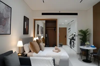 a living room with a white couch and a table at Lux Business Bay Studio with Jacuzzi & Canal View in Dubai