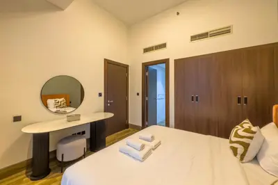 a hotel room with a bed and a mirror at Modern Living with Canal Views, Near Burj Khalifa and World Trade Center in Dubai