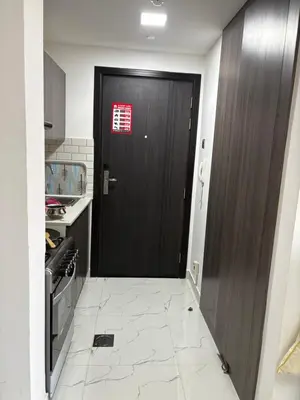a black door with a red sign on it in a kitchen at Dubailand in Dubai