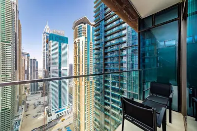 a balcony with a view of a city at Luxury living , Triple pool access at Marina views in Dubai