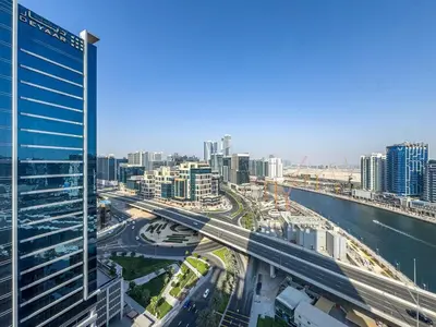 a view of a city with a river and buildings at Elegant Studio Business Bay - Balcony with Skyline Views in Dubai