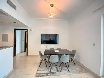 a dining room with a table and chairs at Stylish 1BR Apt with Canal Views in Dubai