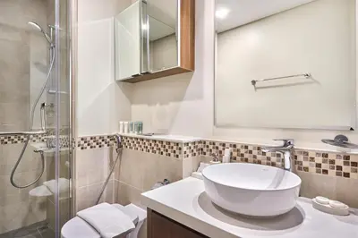 a bathroom with a sink and a shower at Cozy 1BR Vera Tower with Amazing Burj Khalifa View in Dubai