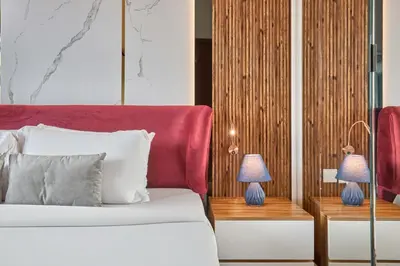 a bedroom with a bed and two lamps on tables at Cozy 1BR Vera Tower with Amazing Burj Khalifa View in Dubai