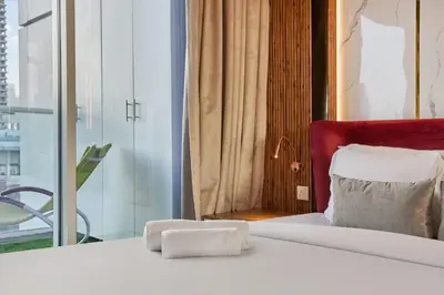 a hotel room with a bed and a window at Cozy 1BR Vera Tower with Amazing Burj Khalifa View in Dubai