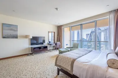 a hotel room with a bed and a large window at SuperHost EMAAR Residences Fashion Avenue - Former Address Dubai Mall Studio's & 1 BR in Dubai
